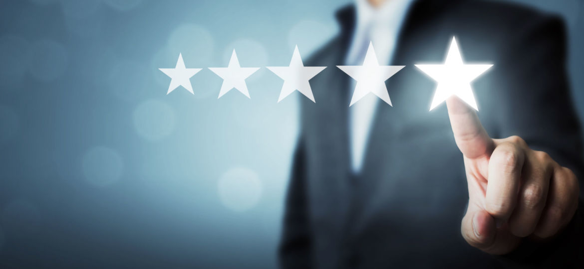 Businessman pointing five star symbol to increase rating of company